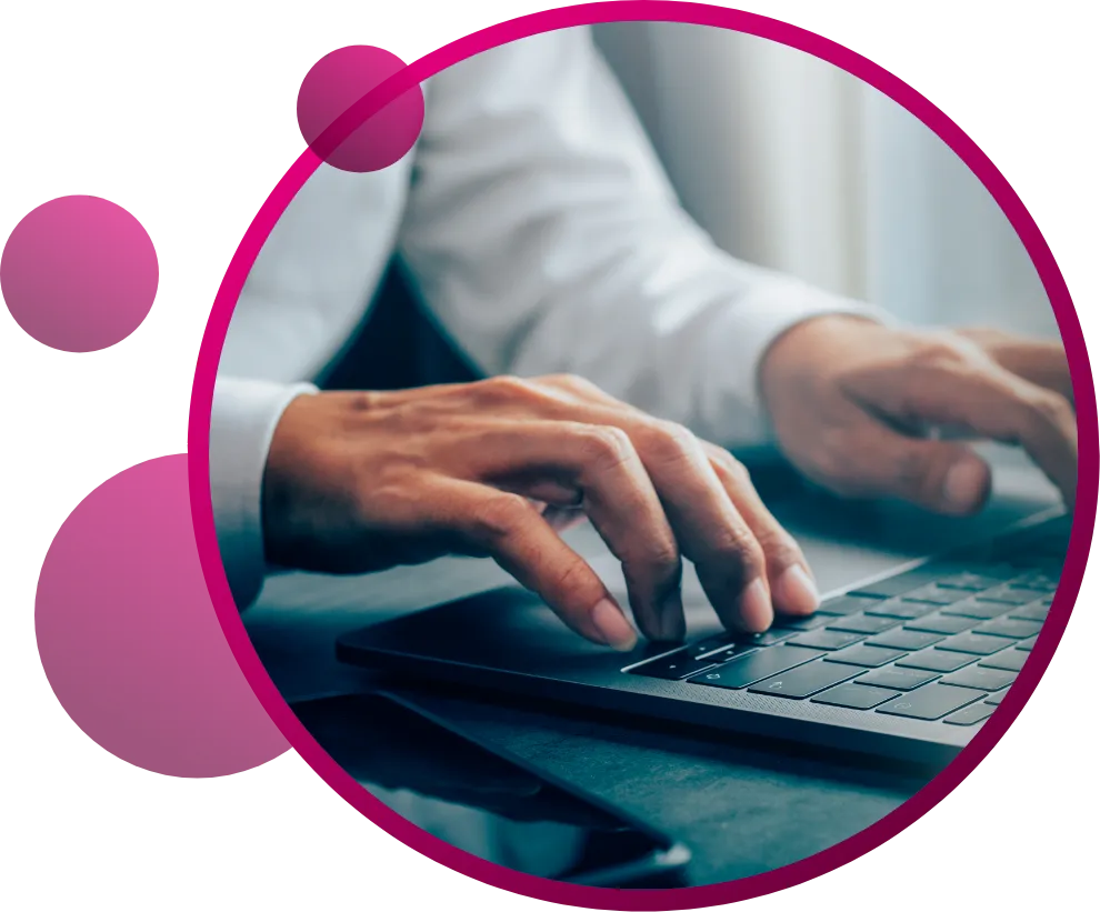 Hands typing on a laptop