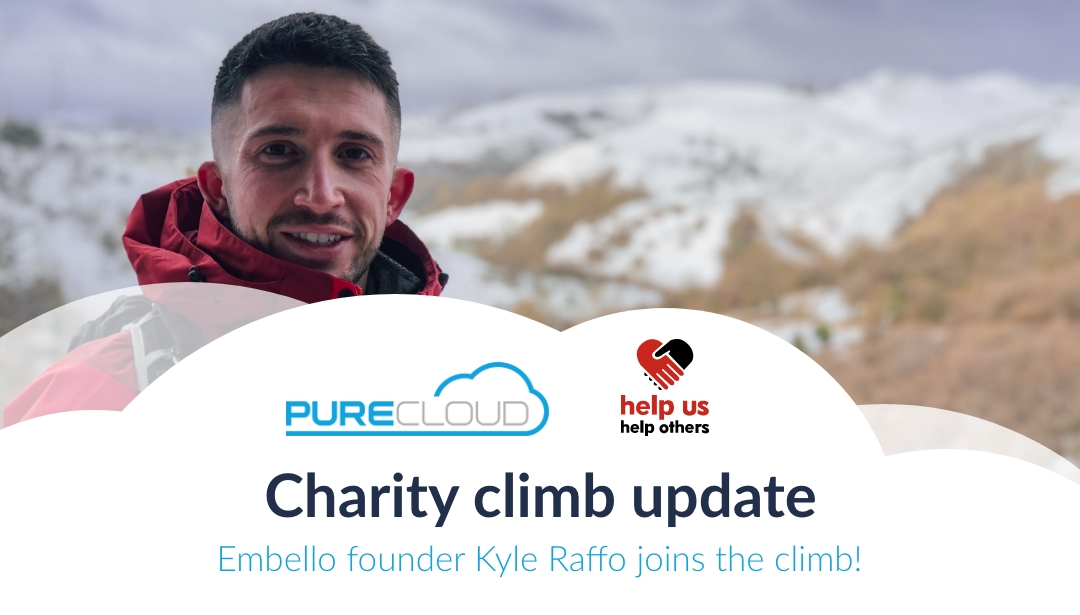Kyle Raffo, founder of Embello, smiling during a charity climb with snow-covered mountains in the background.