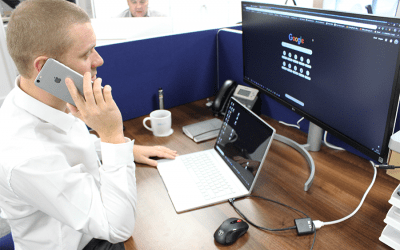 PureCloud employee on the phone, looking at a monitor